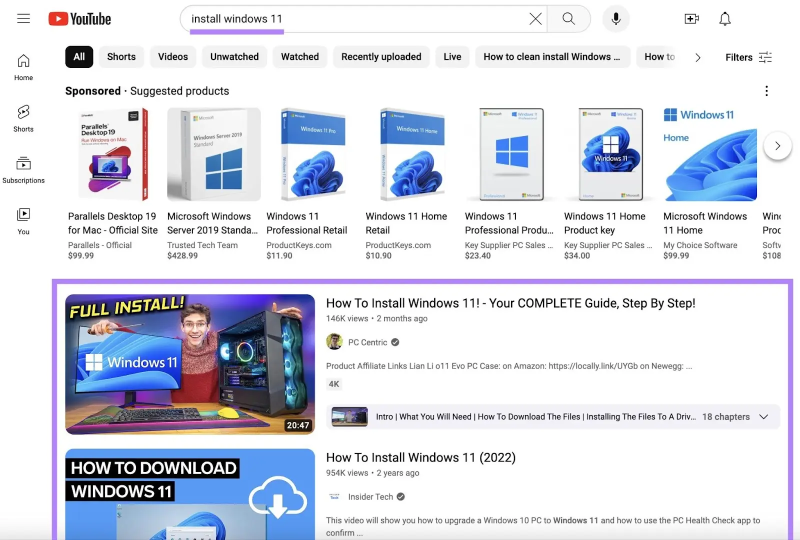 YouTube search results for 'install windows 11' showing sponsored product ads and organic results below them